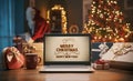 Christmas wishes on a laptop and Santa bringing gifts at home Royalty Free Stock Photo