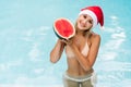 Christmas woman beautiful smiling in Santa`s hat with watermelon Royalty Free Stock Photo