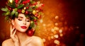 Christmas Woman Beauty. Beautiful Girl in Fir Tree Wreath with Xmas Ornaments Decor. Women Face Skin and Hands Winter Care. Royalty Free Stock Photo