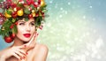 Christmas Woman Beauty Makeup, Xmas Wreath Hairstyle. Winter Fashion Model Portrait, Red Lips Make up, Beautiful Girl on Blue Snow Royalty Free Stock Photo