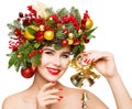 Christmas Woman Gift Bells. Beautiful Girl Fashion Make up and Xmas Party Wreath Hairstyle. Isolated White