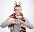 Christmas, woman and heart with smile in portrait for festive, winter and holiday on studio backdrop. Female person Royalty Free Stock Photo