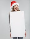 Christmas woman hold big white card. Santa hat. Isolated Royalty Free Stock Photo