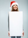 Christmas woman hold big white card. Santa hat. Isolated Royalty Free Stock Photo