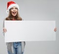 Christmas woman hold big white card. Santa hat. Isolated Royalty Free Stock Photo