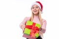 Christmas woman holding giving gift excited pointing. Happy smiling woman in santa hat giving you a present being joyful, fresh an Royalty Free Stock Photo