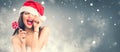 Christmas woman. Joyful model girl in Santa`s hat with red lips and lollipop candy in her hand Royalty Free Stock Photo