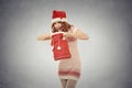 Christmas woman in santa claus red hat holding opening gift bag Royalty Free Stock Photo