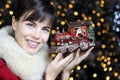 Christmas woman smiling with train toy in lights background Royalty Free Stock Photo