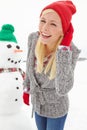 Christmas, woman and snowman outdoor in winter, happy smile and cold in Austria during festive holiday or season. Young Royalty Free Stock Photo