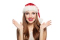 Christmas woman wearing Santa hat isolated on white. Happy surprised model girl Royalty Free Stock Photo