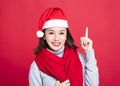 Christmas woman wearing santa hat and pointing up Royalty Free Stock Photo