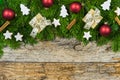 Christmas background with gift boxes, fir branches border, star cookies and ornaments Royalty Free Stock Photo