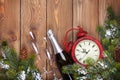 Christmas wooden background with clock, champagne and snow fir t Royalty Free Stock Photo