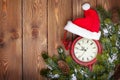 Christmas wooden background with clock and snow fir tree Royalty Free Stock Photo
