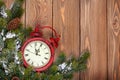 Christmas wooden background with clock and snow fir tree Royalty Free Stock Photo