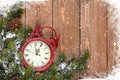 Christmas wooden background with clock and snow fir tree Royalty Free Stock Photo