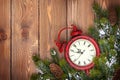 Christmas wooden background with clock and snow fir tree Royalty Free Stock Photo