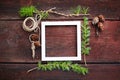 Christmas wooden background. Fir branches and cones with white frame for copyspace. Royalty Free Stock Photo