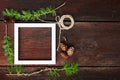 Christmas wooden background. Fir branches and cones with white frame for copyspace. Royalty Free Stock Photo