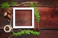 Christmas wooden background. Fir branches and cones with white frame for copyspace. Royalty Free Stock Photo