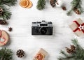 Christmas wooden background with fir branches, gifts, camera and decoration. Xmas and Happy New Year holiday. Flat lay, top view Royalty Free Stock Photo