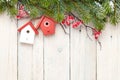 Christmas wooden background with fir tree and birdhouse decor Royalty Free Stock Photo