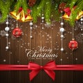 Christmas wooden background with fir tree, red and white balls, gold bells and red bow Royalty Free Stock Photo