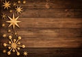 Christmas Wooden Background with Golden Stars and Snowflakes. Xmas Ornament Design on brown Wood Table with Copy Space