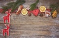 Christmas wooden background with homemade Christmas cookies, deer, cinnamon and Christmas tree. Toned, copy space Royalty Free Stock Photo