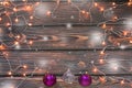 Christmas wooden background with lights, snow and ornaments Royalty Free Stock Photo