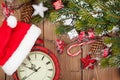 Christmas wooden background with snow fir tree, decor and clock Royalty Free Stock Photo