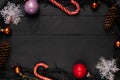 Christmas wooden board black background garland candies toy tree cone top view Royalty Free Stock Photo