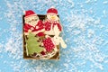 christmas wooden decorative figures in gift box on blue background Royalty Free Stock Photo