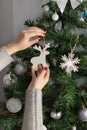 Christmas wooden deer in the hands of a little girl. Christmas tree decor. Preparation concept. Royalty Free Stock Photo