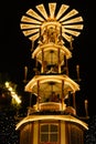 Christmas wooden pyramid rotates with nativity scene, people walking during Christmas market, German Night street Xmas and holiday Royalty Free Stock Photo