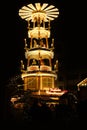 Christmas wooden pyramid rotates with nativity scene, people walking during Christmas market, German Night street Xmas and holiday Royalty Free Stock Photo