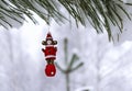 Christmas wooden toy bear on a snow-covered pine branch in the winter forest. Christmas background with copy space Royalty Free Stock Photo