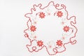 Christmas wooden toys in the form of a white angel and a red snowflake with red beads are laid out in a circle with a place for Royalty Free Stock Photo