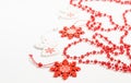 Christmas wooden toys in the form of a white angel and a red snowflake with bright red beads on a white background Royalty Free Stock Photo