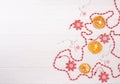 Christmas wooden toys in the form of a white angel, a red snowflake, dried orange slices, red beads with space for copy space with Royalty Free Stock Photo