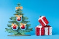 Christmas wooden tree and christrmas presents decoration on blue background.Christmas decoration Royalty Free Stock Photo