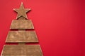 Christmas wooden tree on red background, copy space. new year winter greeting card Royalty Free Stock Photo