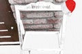 Christmas wooden welcome sign board rack covered in snow and decorated with a santa claus hat Royalty Free Stock Photo