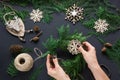 Christmas workshop of wreath, decor, twine, twigs and snowflakes. Woman prepare a wreath. Top v Royalty Free Stock Photo