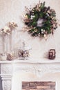 Christmas wreath above classical fireplace