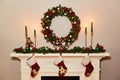 Christmas wreath above classical fireplace. Xmas scene. Place for text