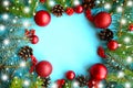 Christmas composition. Frame of fir branches and red Christmas baubles on blue background. Beautiful Xmas greeting card. Copy spac Royalty Free Stock Photo