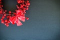 Christmas wreath and bow on a black canvas background Royalty Free Stock Photo