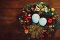 Christmas wreath with burning candles on wooden table. Royalty Free Stock Photo